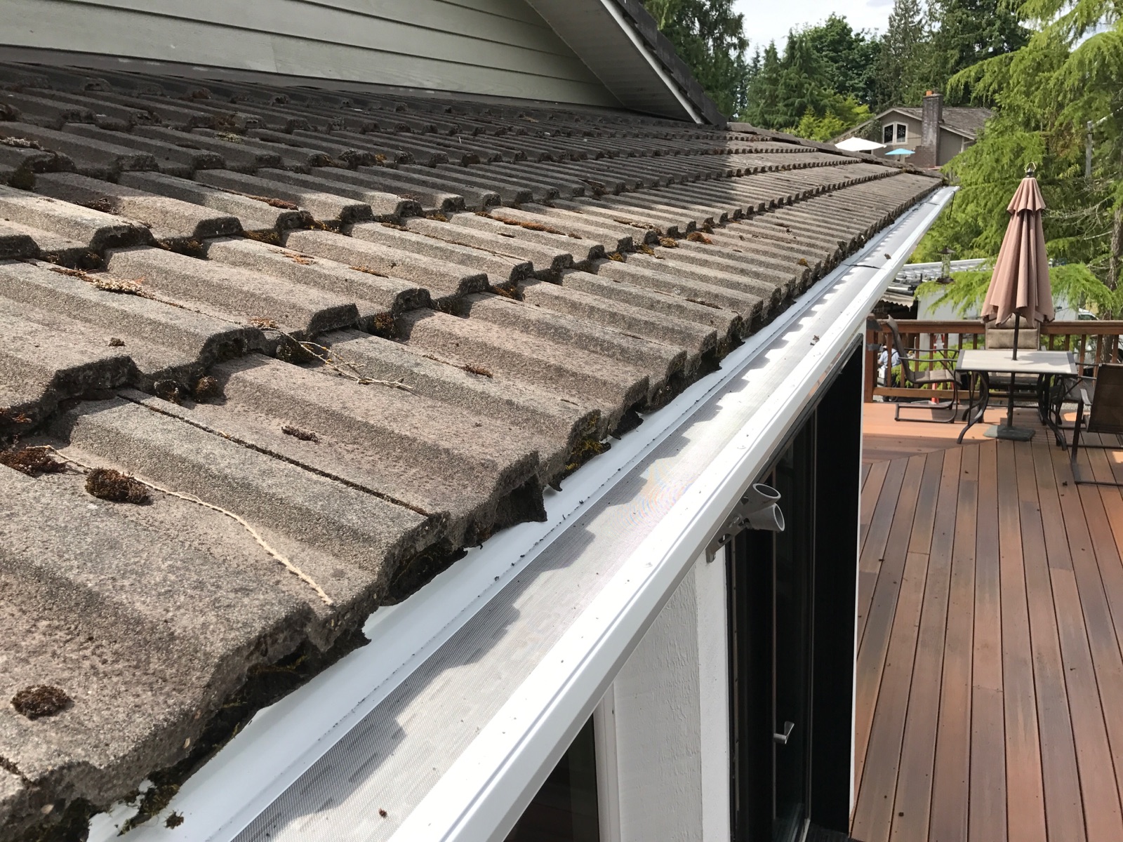 Clean newly installed gutters along a home roofline